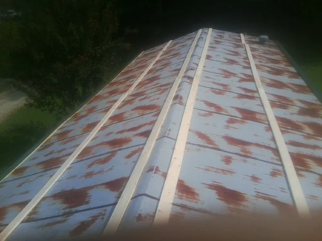 Rusted metal roof panels with new wood purlins before replacement — Storm Damage Roof Repair in Marysville by Roofing Brothers